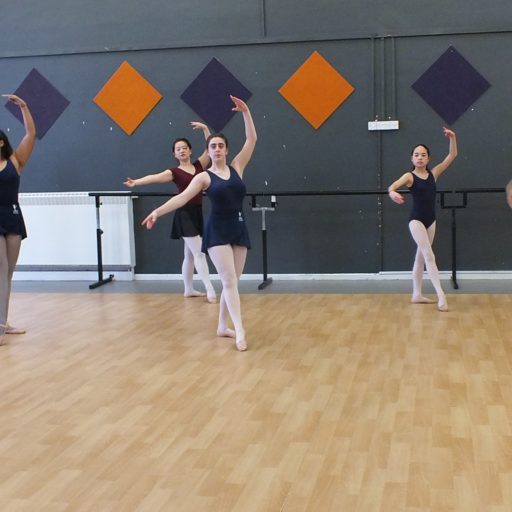 6 dancers pausing with foot in front